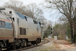 AMTK 77 leads train P080-26 away from the station